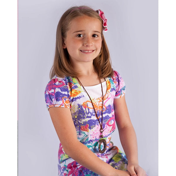 White backdrop little girl model sitting on  posing stool