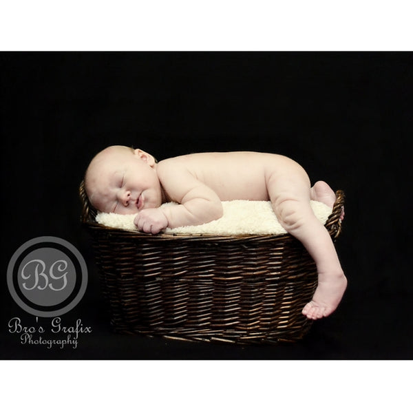 newborn portrait on black fabric backdroprop