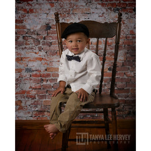 Brick Floordrop being used as a backdrop with boy model posing in chair