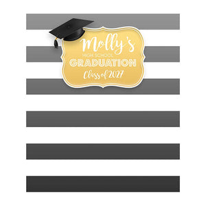 Graduation backdrop with wide gray and white horizontal stripes, a gold decorative plaque reading Molly's High School Graduation Class of 2027, and a black graduation cap with tassel.