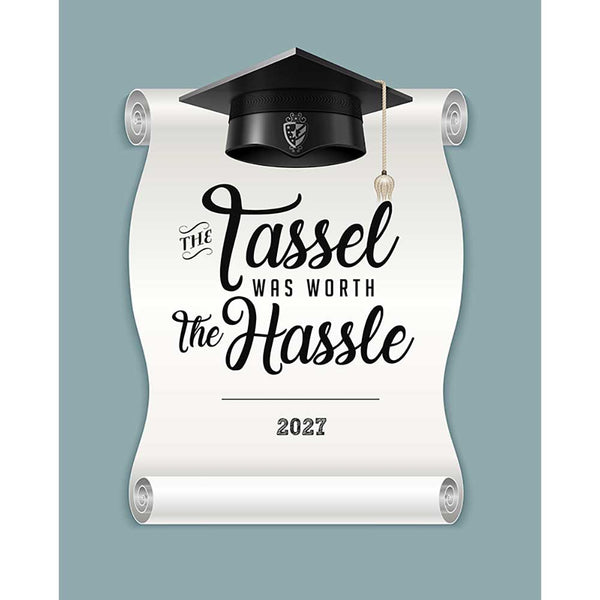 Blue gray graduation backdrop with a white diploma scroll, black graduation cap and tassel, 2027, and decorative lettering reading The Tassel Was Worth The Hassle.