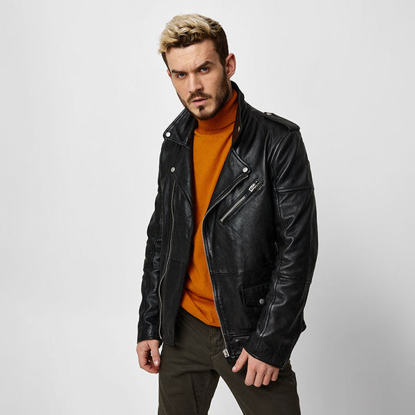 A person standing against a bright white seamless paper backdrop, which is commonly used for photography.