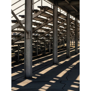 Photography backdrop featuring the geometric shadows and structural lines beneath stadium bleachers—ideal for sports-themed portraits, senior photos, and urban-style editorial shoots.